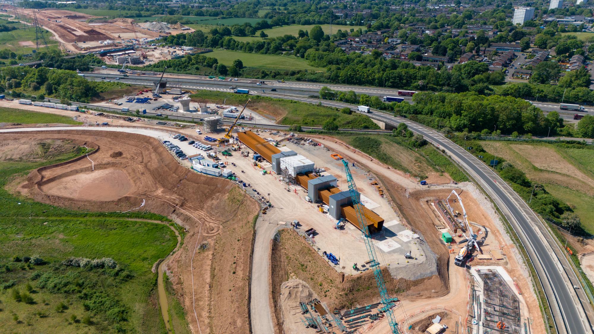 Aerial view of the first section of the M6 South viaduct being assembled alongside the road May 2025.jpg